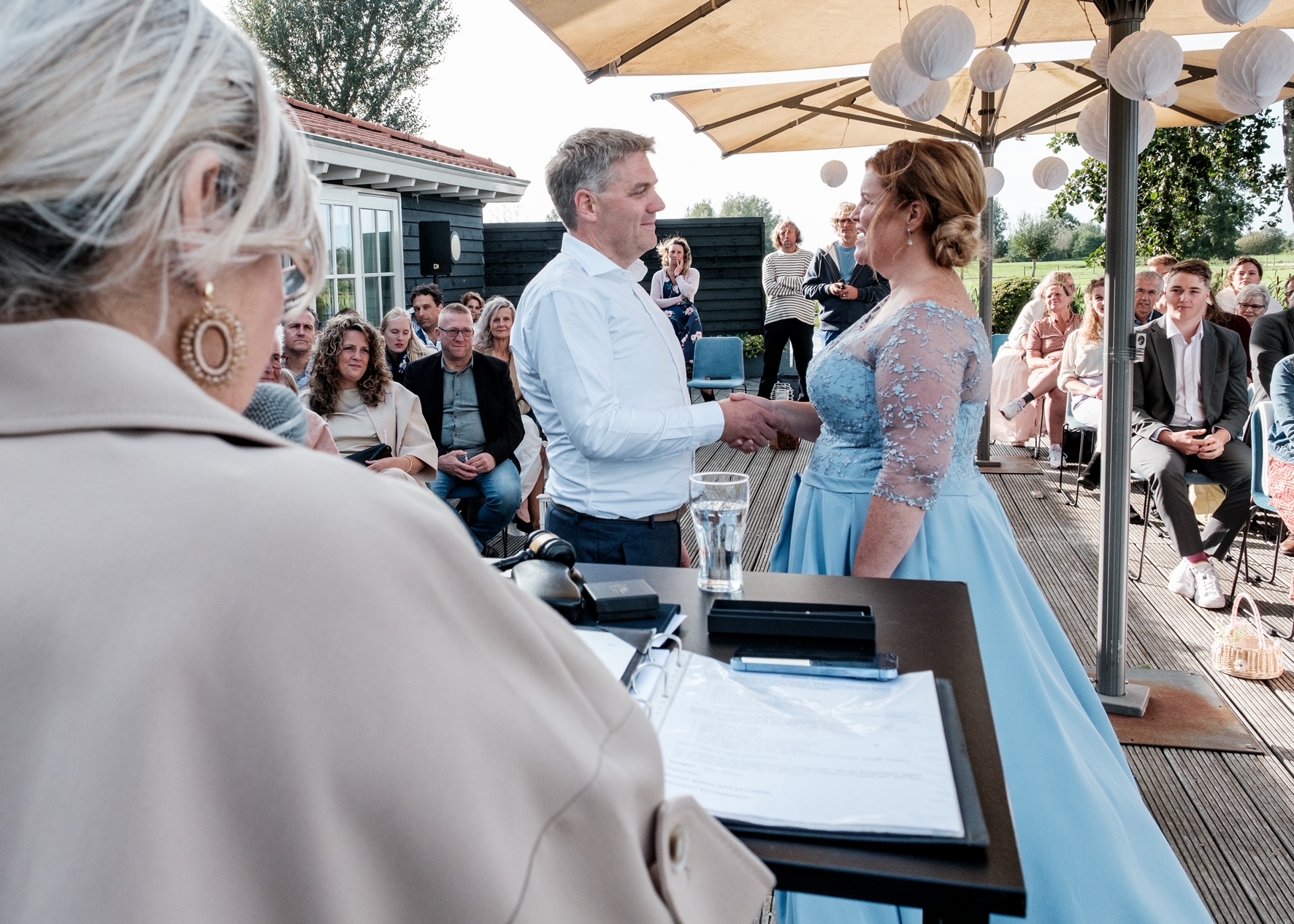 Esther spreekt een bruidspaar toe tijdens een buitenceremonie